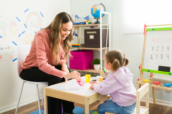 Therapist doing a craft activity with a young girl