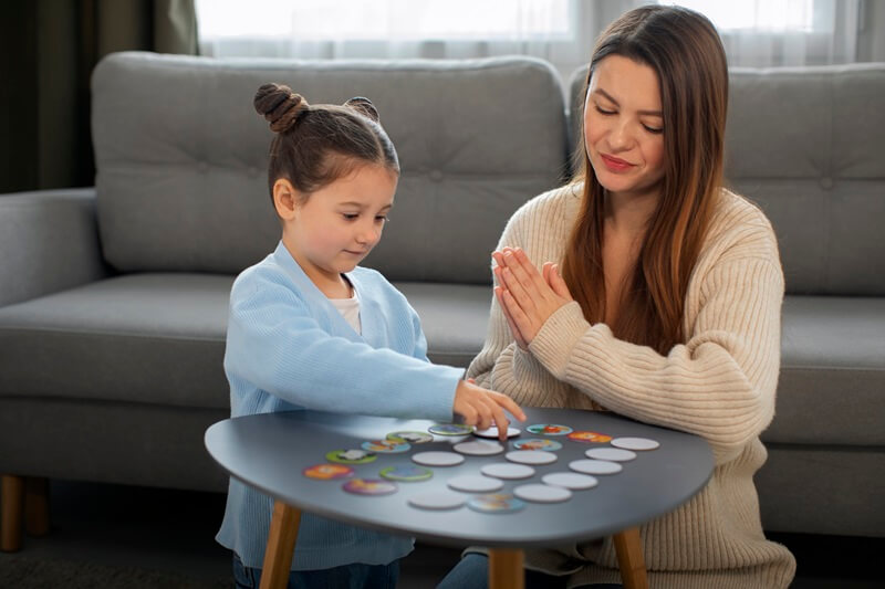 Girl and therapist playing a matching game