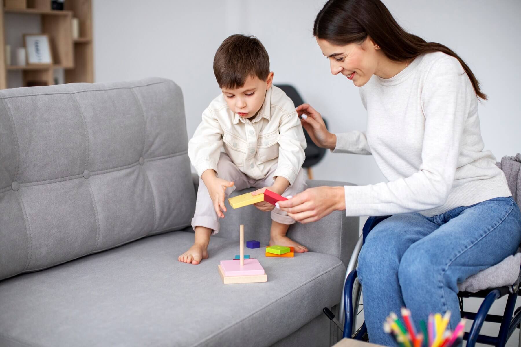 A child and an adult playing with a stacking toy