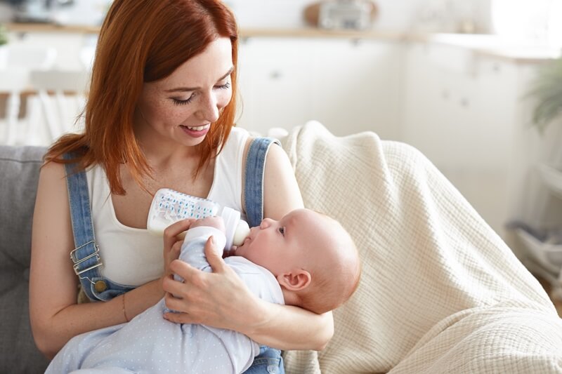 Mother bottle-feeding her baby