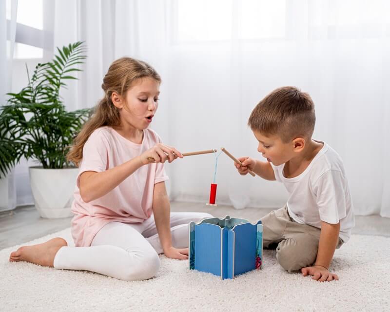 Two children playing a game with sticks